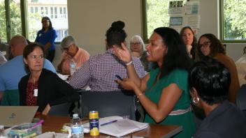 woman talking and others listening