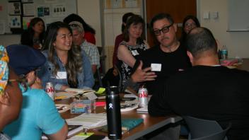 man talking and others listening