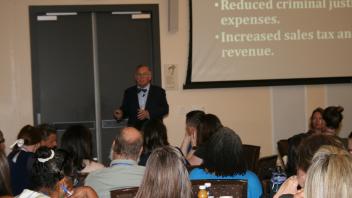 Presenter speaking to room of leaders