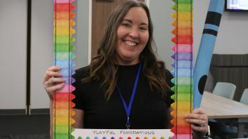 educator with crayon and picture frame props