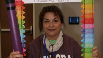 educator with crayon and picture frame props
