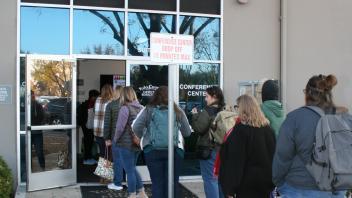 educators waiting outside conference center 