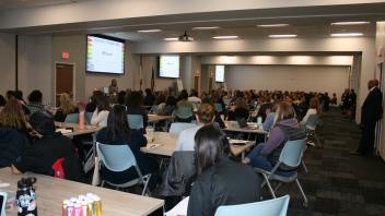 educators listening to presenters in conference room