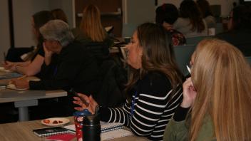 educators listening to presentation in conference room