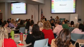 educators listening to presentation in conference room