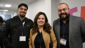 2 men and 1 woman at conference