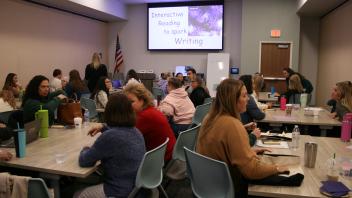 educators listening to presentation in conference room