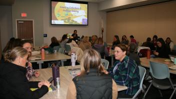 educators listening to presentation in conference room