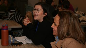 two women smiling and talking