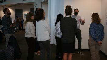 man talking to group standing