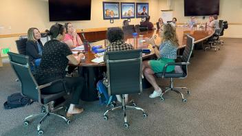 small group of people, seated and talking